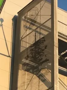 Close-up detail of decorative metal mesh facade with tree decoration, Pure Metal Tech® by Dreamet